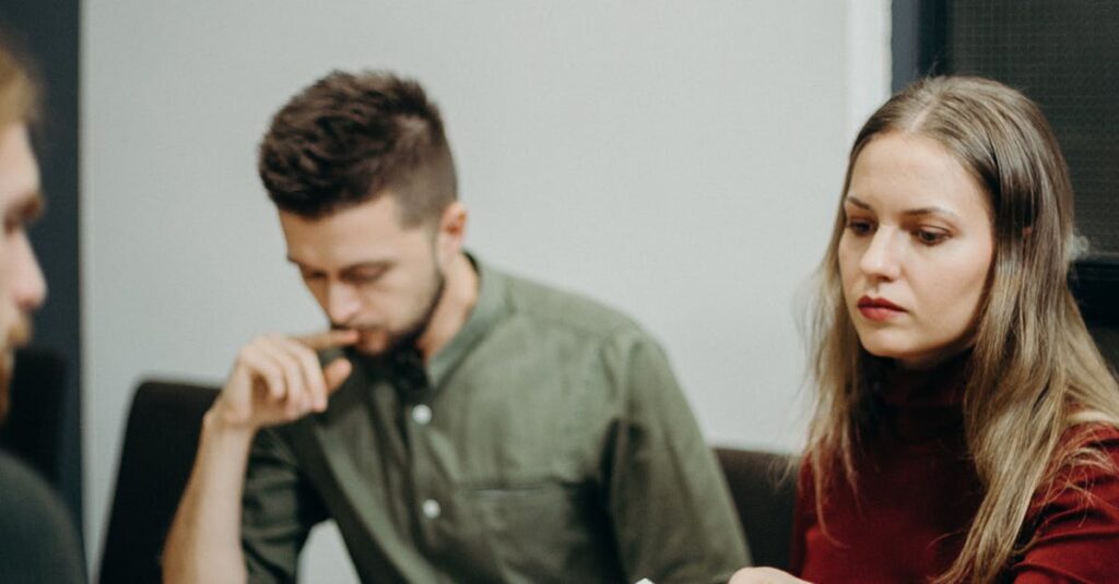pexels photo 3205567 3205567 A team of adults discussing documents in an office meeting setting, focusing on collaboration.