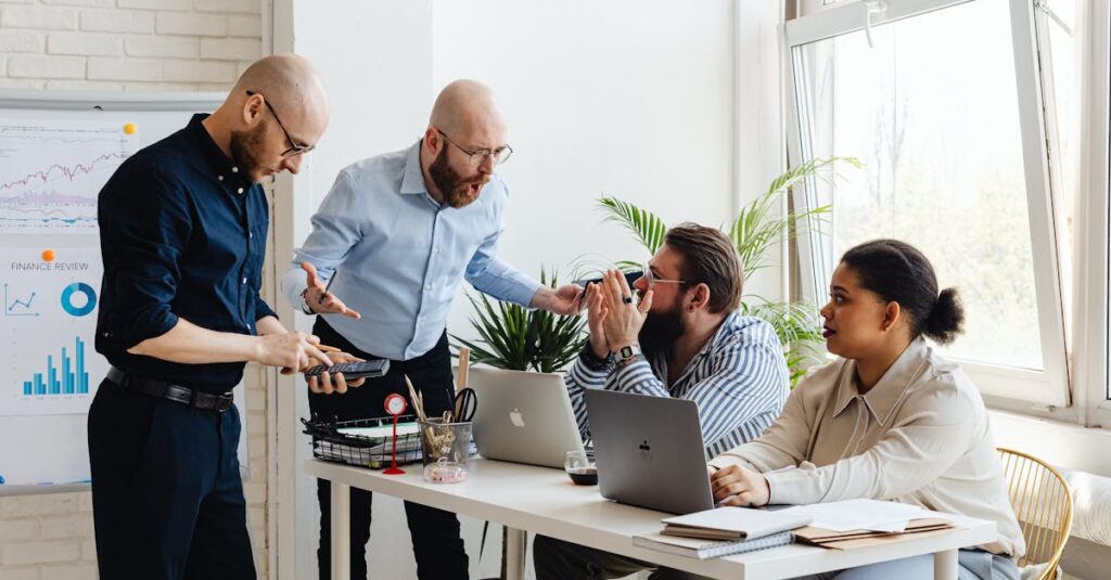 pexels photo 7876896 7876896 Group of diverse professionals engaged in a lively office discussion around a desk.